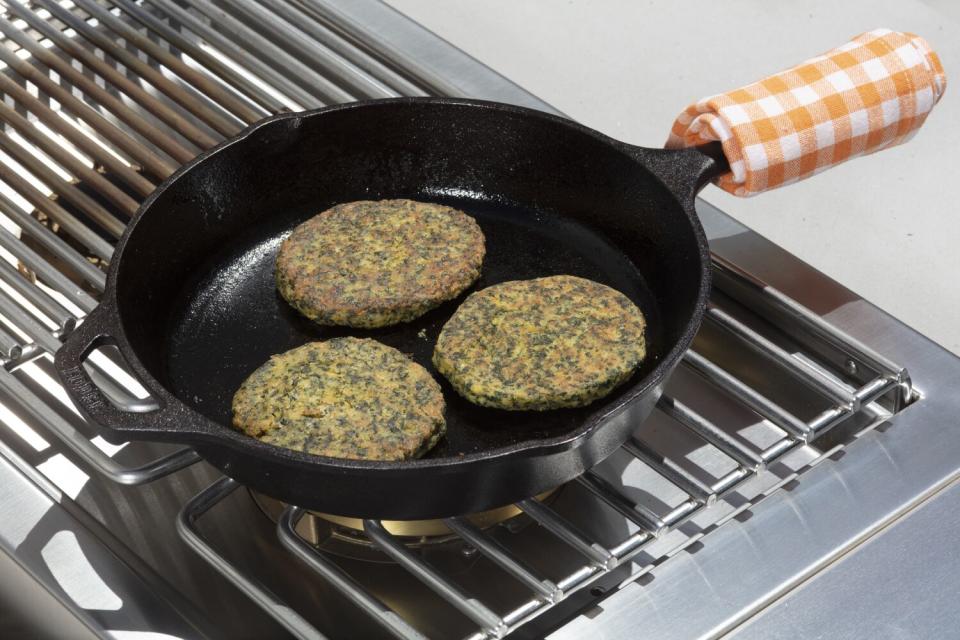 Spinach-chickpea veggie burger patties on the grill