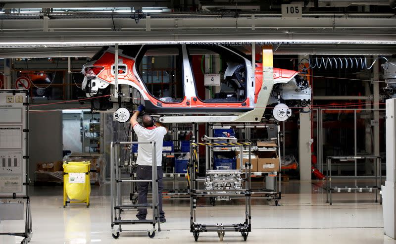 FILE PHOTO: Workers assemble vehicles on the assembly line of the SEAT car factory in Martorell