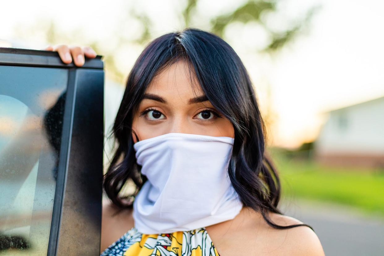 Generation Z Female Next to Automobile with Scarf as Face Mask Covering