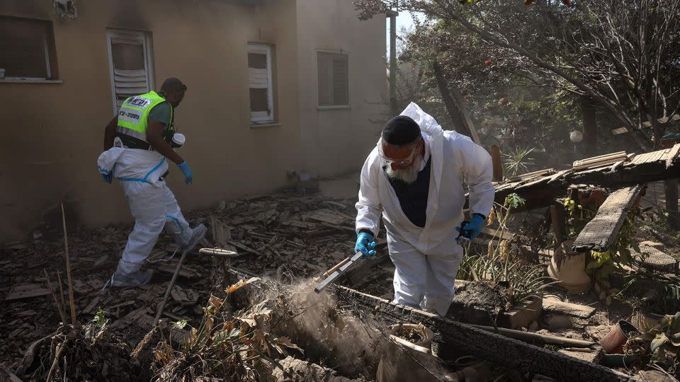 Volunteers from Israeli volunteer-run emergency rescue service ZAKA search through debris in Be'eri, a kibbutz near the border with Gaza, on October 20, 2023. - Ronaldo Schemidt/AFP/Getty Images