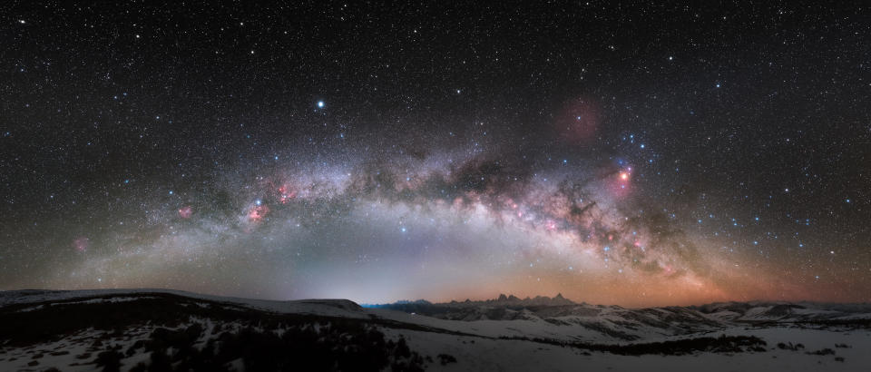 milky way streaking over the horizon