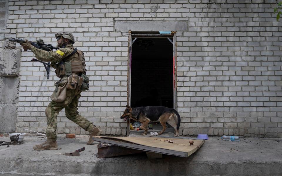 A Ukrainian serviceman patrols during a reconnaissance mission in a recently retaken village on the outskirts of Kharkiv