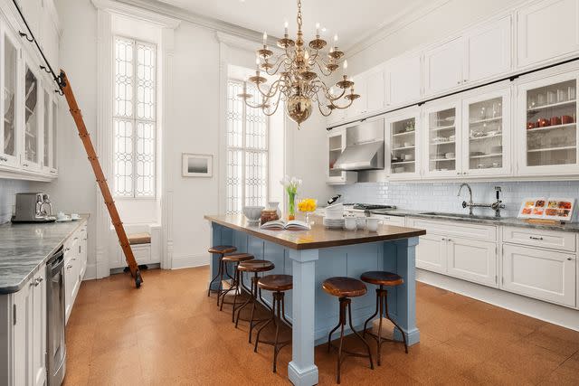 <p>Evan Joseph/Sotheby's International Realty</p> A photo taken of the apartment's kitchen, which features a rolling ladder.