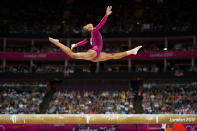 <p>Douglas soared over the balance beam apparatus during her gold medal performance in the women’s gymnastics individual all-around finals on August 2, 2012. (David Eulitt/Kansas City Star/MCT via Getty Images) </p>