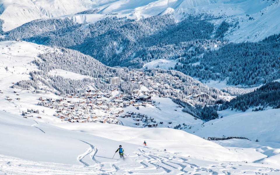 Beautiful snow capped mountains with Arosa village, Switzerland - Getty