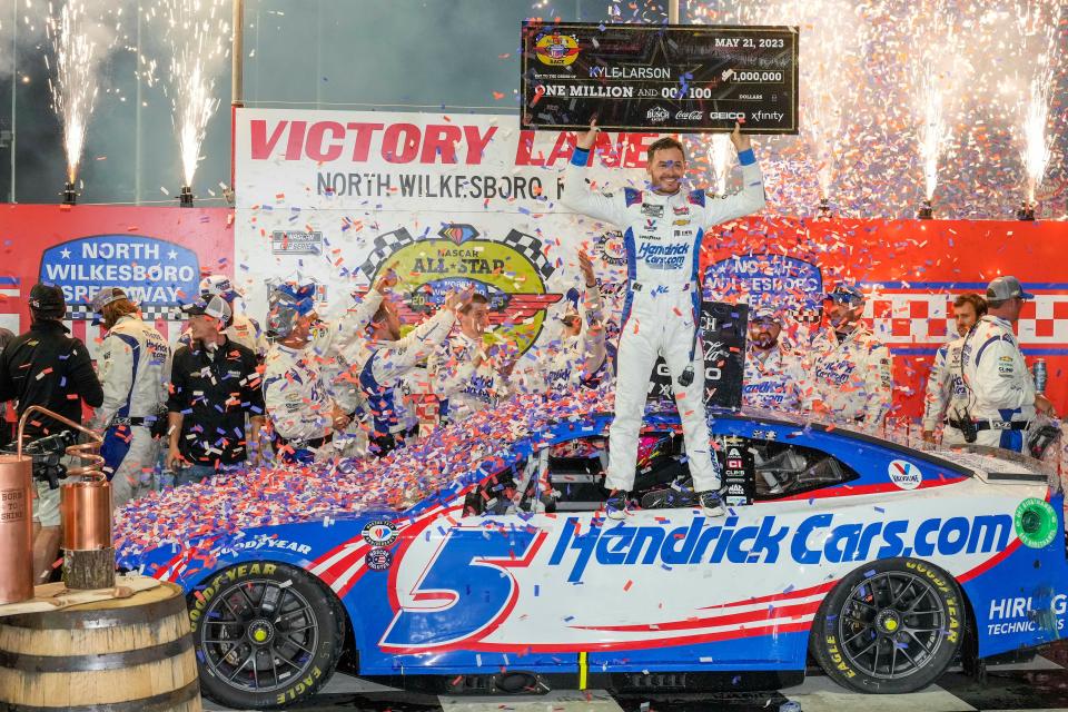 Kyle Larson celebrates with the $1 million check after winning the NASCAR All Star Race at North Wilkesboro Speedway on May 21, 2023.