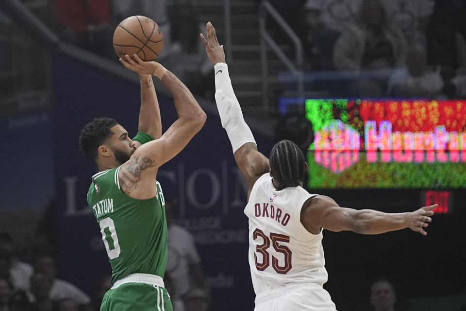 Boston Celtics forward Jayson Tatum shoots as Cleveland Cavaliers forward Isaac Okoro (35) defends during the first half of Game 3 of an NBA basketball second-round playoff series Saturday, May 11, 2024, in Cleveland. (AP Photo/Sue Ogrocki)