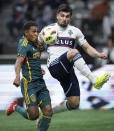 LA Galaxy's Mauricio Cuevas, left, and Vancouver Whitecaps' Brian White vie for the ball during the second half of an MLS soccer match Saturday, April 13, 2024, in Vancouver, British Columbia. (Darryl Dyck/The Canadian Press via AP)