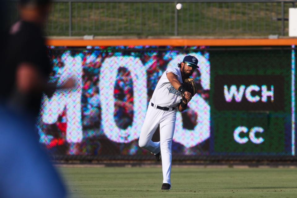 The Hooks' Jose Alvarez (18) throws out a runner at first base after catching a fly ball in a game against the Wichita Wind Surge on Tuesday, May 24, 2022 at Whataburger Field. The Hooks lost 8-3.
