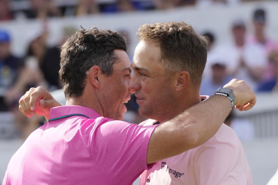 Rory McIlroy, left, hugs Justin Thomas on the 18th green after winning the Canadian Open golf tournament in Toronto on Sunday, June 12, 2022. (Frank Gunn/The Canadian Press via AP)
