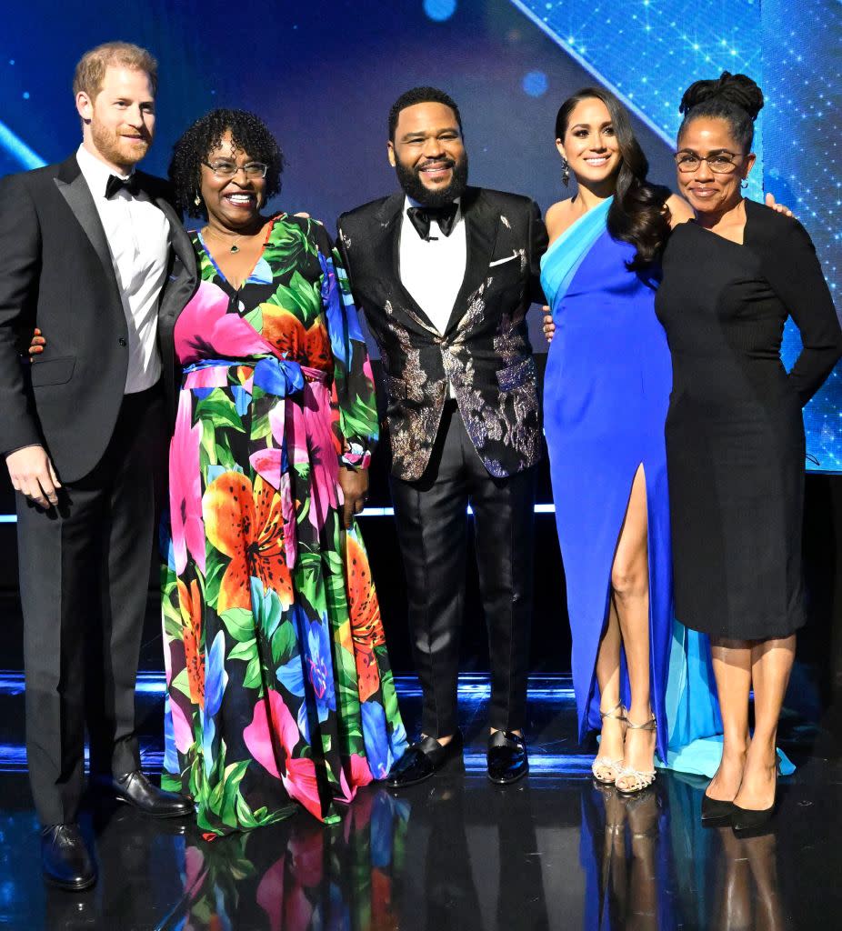 Prince Harry and Meghan Markle with Anthony Anderson. Earl Gibson III/Shutterstock