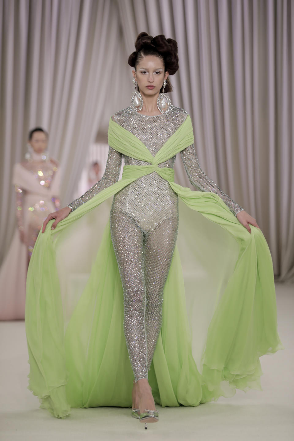 A model wears a creation as part of the Giambattista Valli Haute Couture Spring-Summer 2023 collection presented in Paris, Monday, Jan. 23, 2023. (AP Photo/Lewis Joly)