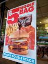 Signs advertising menu items are seen at fast food restaurants in New York City