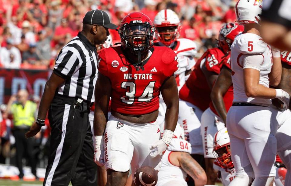 N.C. State running back Delbert Mimms III (34) celebrates after scoring on a one-yard touchdown run during the first half of N.C. State’s game against VMI at Carter-Finley Stadium in Raleigh, N.C., Saturday, Sept. 16, 2023.