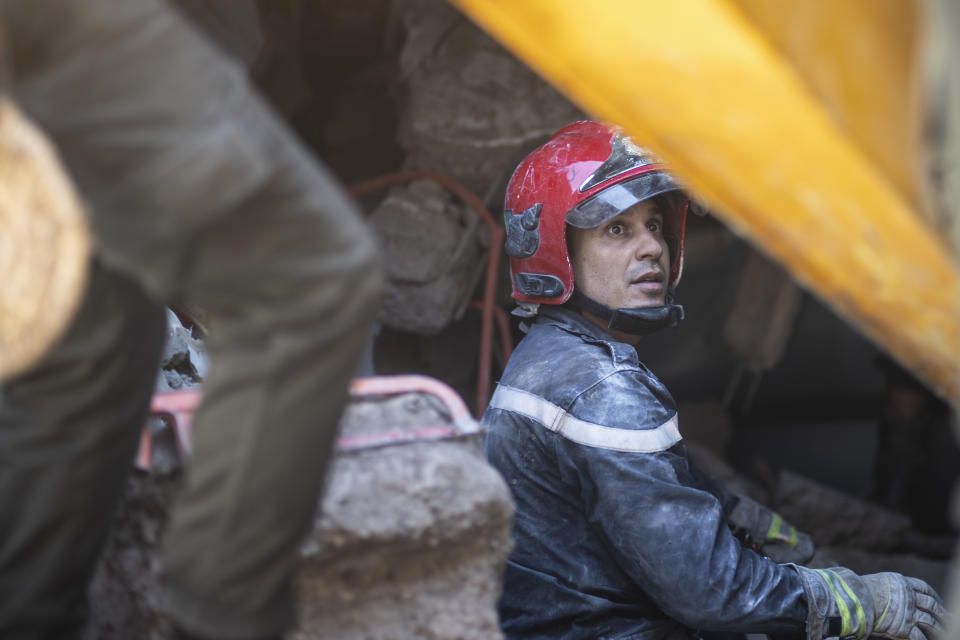 A rescue workers pauses while taking part in a rescue operation after the earthquake, in Moulay Brahim village, near Marrakech, Morocco, Saturday, Sept. 9, 2023. A rare, powerful earthquake struck Morocco late Friday night, killing more than 800 people and damaging buildings from villages in the Atlas Mountains to the historic city of Marrakech. But the full toll was not known as rescuers struggled to get through boulder-strewn roads to the remote mountain villages hit hardest. (AP Photo/Mosa'ab Elshamy)