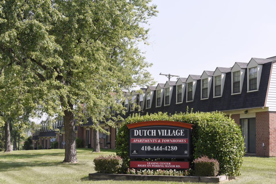 In this Monday, July 29, 2019, photo, a sign sits outside the Dutch Village apartments and townhomes, owned by the Kushner Cos., in Baltimore. Jared Kushner’s family real estate firm owns thousands of apartments and townhomes in the Baltimore area, and some have been criticized for the same kind of disrepair and neglect that the president has accused local leaders of failing to address. (AP Photo/Steve Ruark)