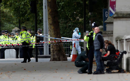 Police and forensic officers stand in the road near the Natural History Museum, after a car mounted the pavement, in London, Britain October 7, 2017. REUTERS/Peter Nicholls