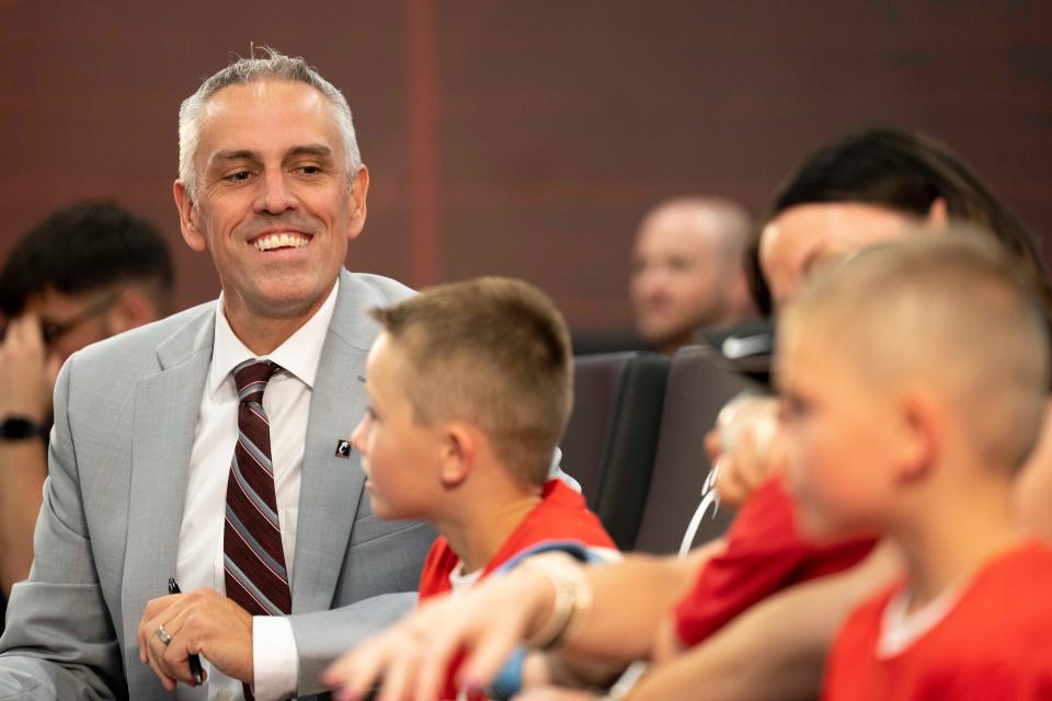 Cincinnati Bearcats head baseball coach Jordan Bischel sits with his family during a press conference at the Lindner Center in Cincinnati on Wednesday, June 21, 2023. 