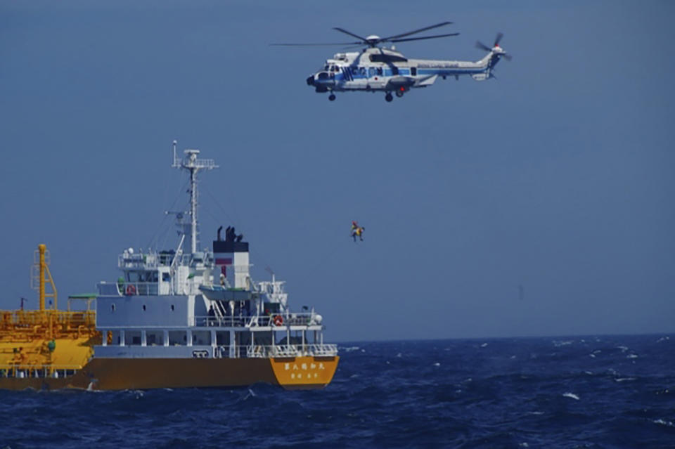 In this photo released by Japan Coast Guard, a woman is airlifted by a coast guard helicopter off Nojimazaki, Chiba prefecture, Japan Wednesday, July 10, 2024. A Chinese woman who was swept out to sea while swimming at a Japanese beach was rescued 37 hours later after drifting in a swimming ring 80 kilometers (50 miles) away in the Pacific Ocean, officials said Thursday. (Japan Coast Guard via AP)