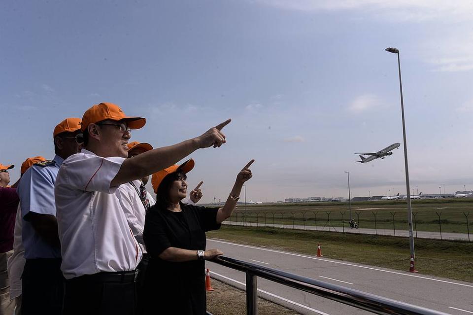 Malaysia Airports Holdings Bhd group chief executive officer Raja Azmi Raja Nazuddin (left) and chairman Tan Sri Zainun Ali check out the planes at the Anjung Spotter observation deck. — Picture Ahmad Zamzahuri