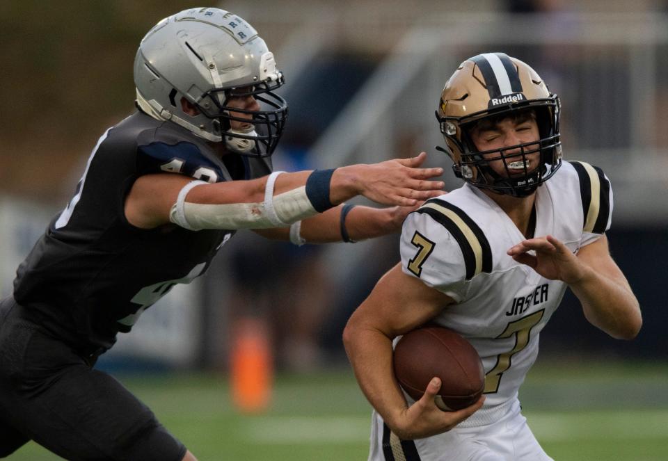 Reitz’s Kole Brantley (40) reaches for the tackle on Jasper’s Grant Young (7) as the Jasper Wildcats play the Reitz Panthers at the Reitz Bowl in Evansville, Ind., Friday evening, Sept. 2, 2022. 