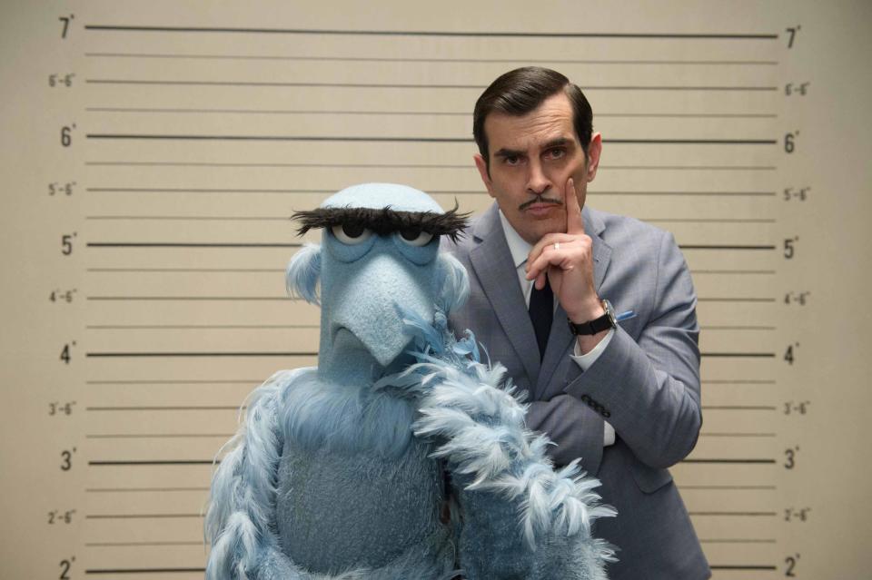 This image released by Disney shows the muppet character Sam the Eagle, left, with Ty Burrell in a scene from "Muppets Most Wanted." (AP Photo/Disney Enterprises, Inc.)