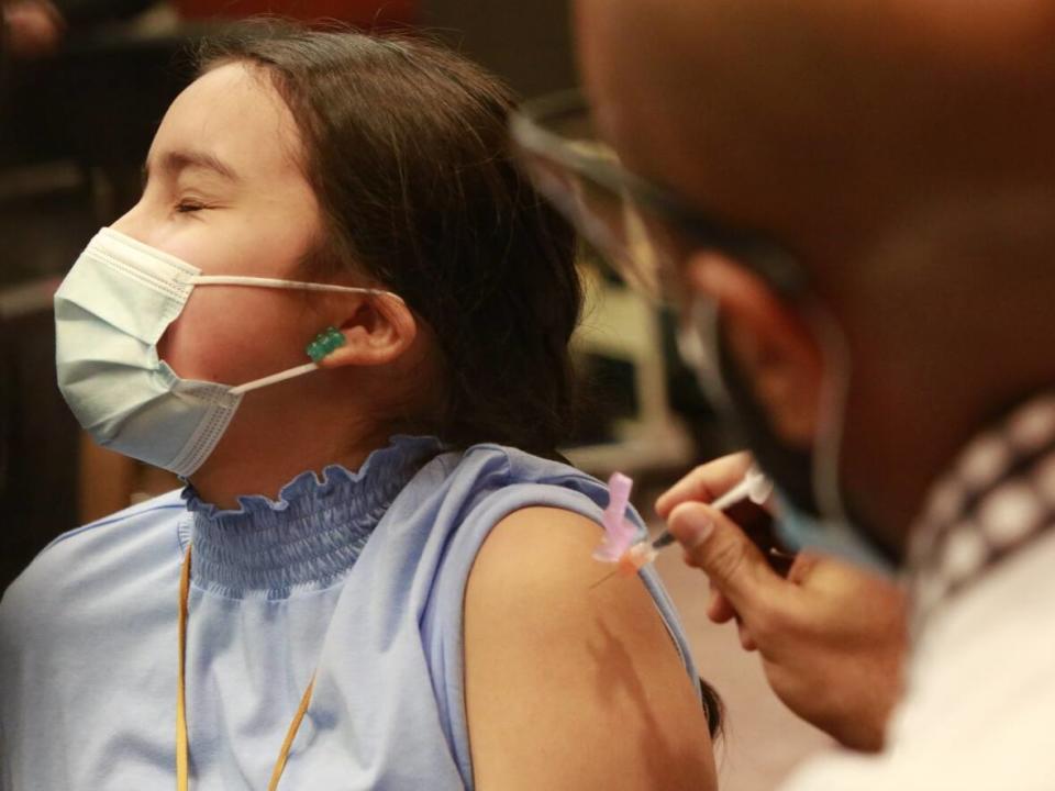 Ava Meconse, 9, gets her first dose of the pediatric Pfizer-BioNTech COVID-19 vaccine at Winnipeg's RBC Convention Centre on Nov. 25, 2021. (Tyson Koschik/CBC - image credit)