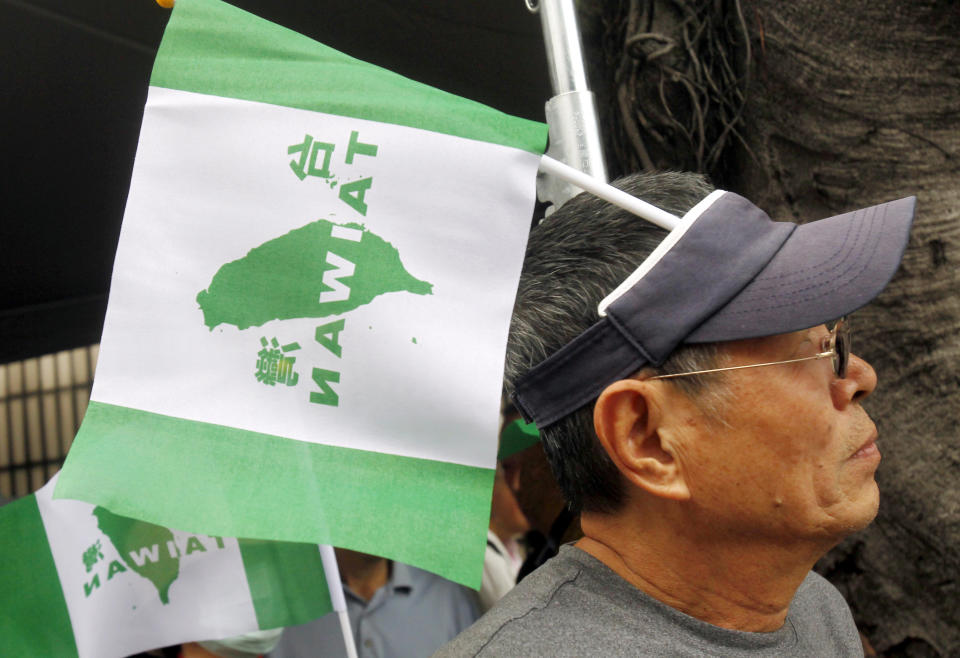 A protester wearing a "Taiwan independence flag" attend a rally in Taipei, Taiwan, Saturday, Oct. 20, 2018. Thousands of pro-independence demonstrators gathered in Taiwan’s capital on Saturday to express their disapproval with China’s stance toward their island. (AP Photo/Chiang Ying-ying)