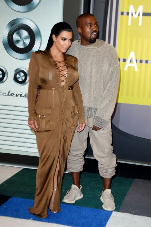 Reality TV star Kim Kardashian and rapper Kanye West arrive on the red carpet at the MTV Video Music Awards at the Microsoft Theater in Los Angeles on August 30, 2015