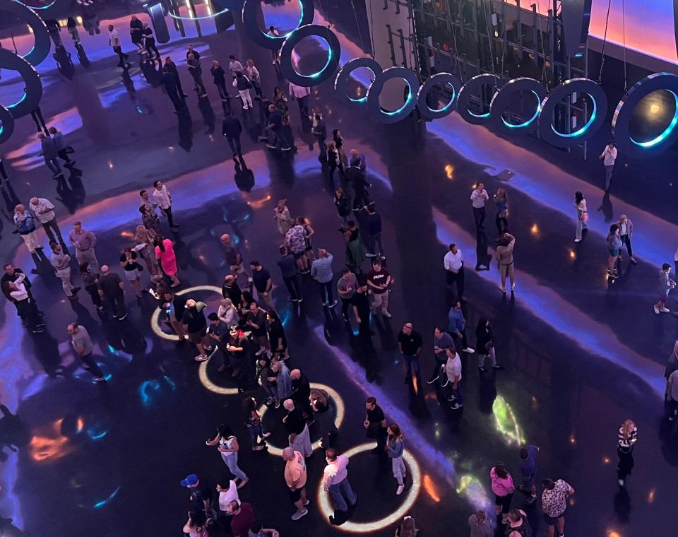 A view of the four gold sound circles from above with people moving around.