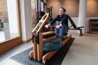 A man tries out a rowing machine in a showroom of U.S. gym equipment manufacturer WaterRower in Munich