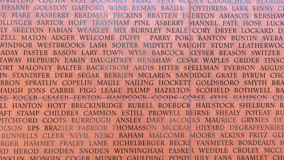 A close up of the last names of the formerly ensalved enscribed on the National Monument to Freedom in Montgomery, Alabama. - Vasha Hunt/AP