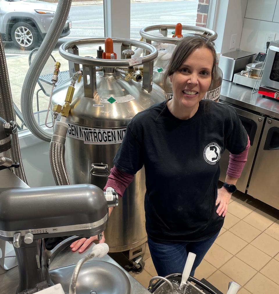 Buzzed Bull Creamery co-owner Tracy Frey stands in front of tanks of liquid nitrogen used to craft the business' specialty ice creams, at the newly opened store in Evans, March 18, 2022.