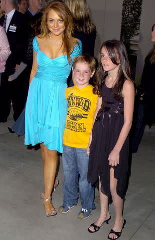 <p>SGranitz/WireImage</p> Lindsay Lohan with her siblings Dakota and Ali in 2004