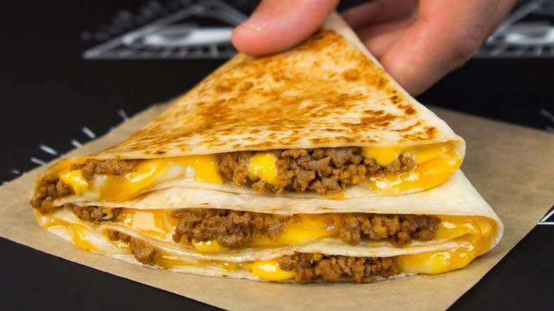 hand grabbing Taco Bell Stacker