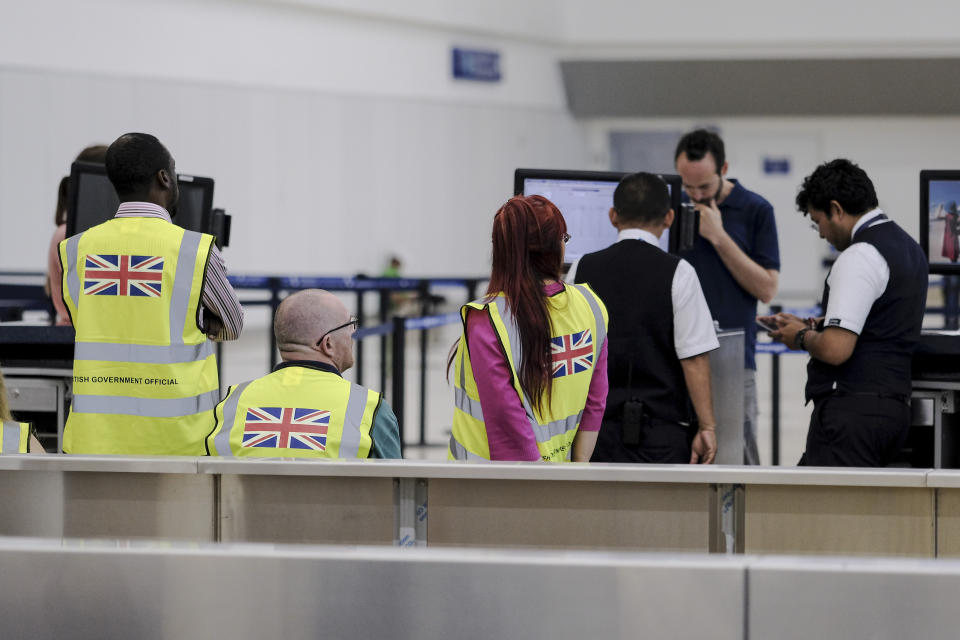 British government officials wait for stranded British passengers at the Cancun airport in Mexico, Monday, Sept. 23, 2019. British tour company Thomas Cook collapsed early Monday after failing to secure emergency funding, leaving tens of thousands of vacationers stranded abroad. (AP Photo/Victor Ruiz)