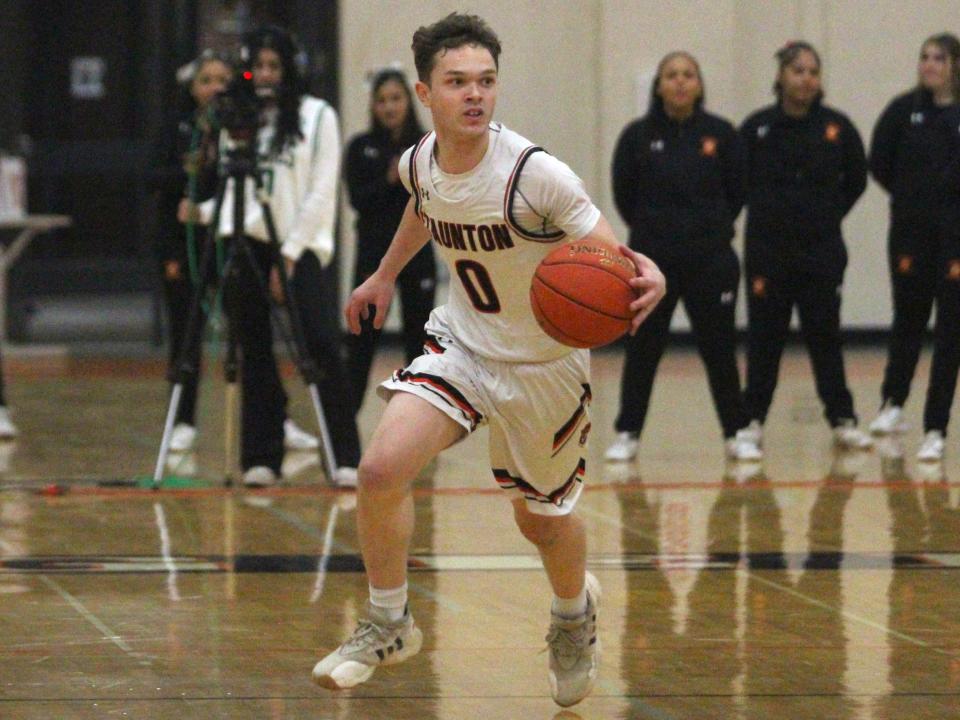 Taunton's Troy Santos dribbles the ball up court during a Hockomock League game against Sharon.