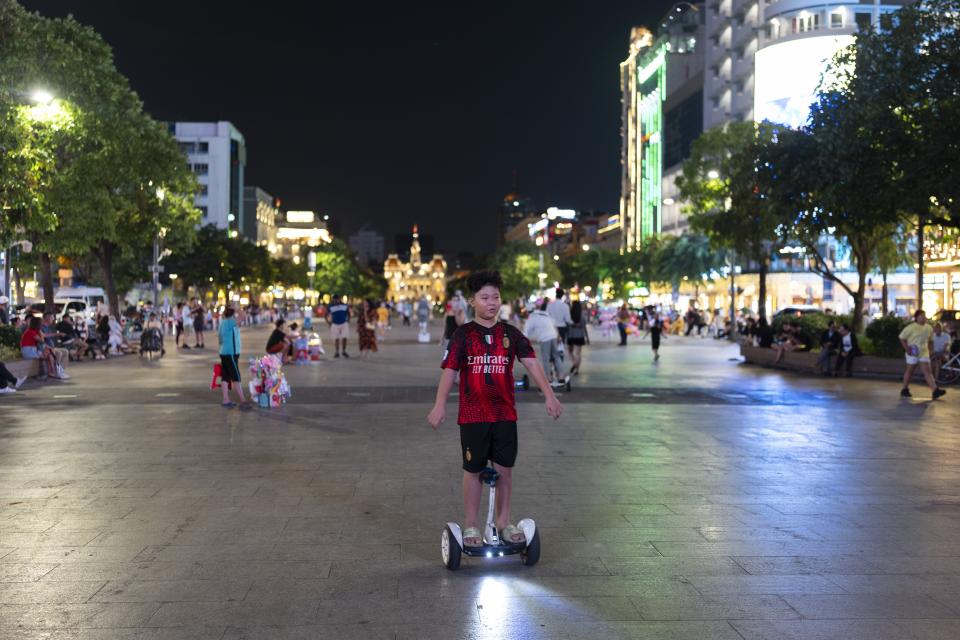 A boy rides an electric hoverboard in Ho Chi Minh City, Vietnam, Jan. 11, 2024. (AP Photo/Jae C. Hong)