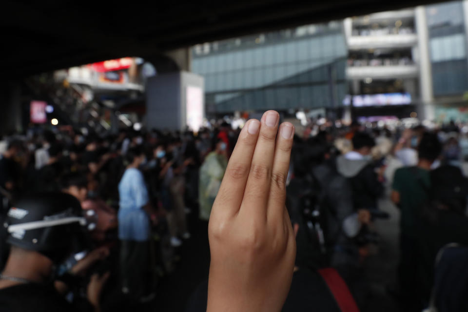 The three-finger protest gesture is flashed during a student rally in Bangkok, Saturday, Nov. 21, 2020. Organized by a group that mockingly calls themselves "Bad Students," the rally calls for educational reforms and also supports the broader pro-democracy movement's demands for constitutional change. (AP Photo/Sakchai Lalit)