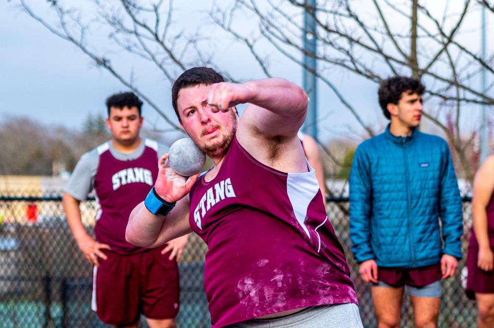 Bishop Stang's Jacob Cookinham competes in the shot put.