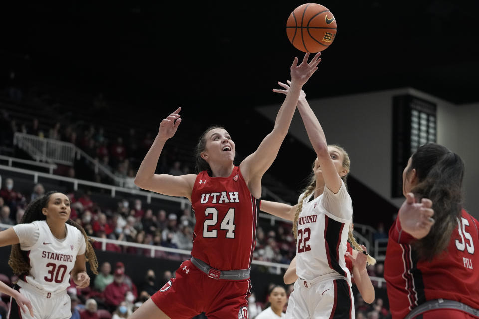 Utah guard Kennady McQueen (24) and Stanford forward Cameron Brink (22) reach for the ball during the first half of an NCAA college basketball game in Stanford, Calif., Friday, Jan. 20, 2023. (AP Photo/Godofredo A. Vásquez)