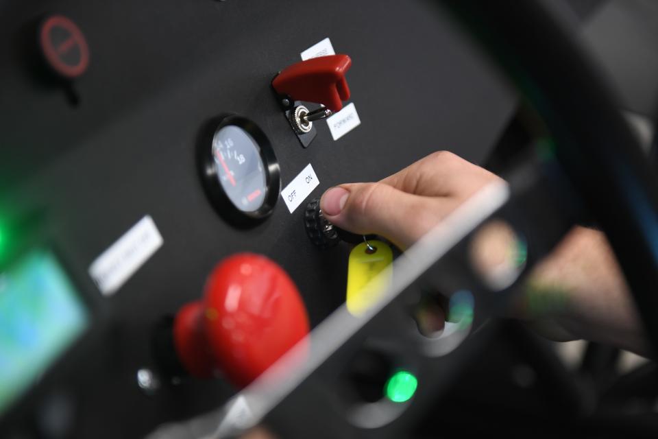 Harrisburg senior Landon Tschetter, 18, starts up the electric car on Wednesday, April 24, 2024, at Tiger Stripes Garage in Harrisburg.