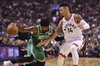 Boston Celtics guard Kyrie Irving (11) controls the ball as Toronto Raptors guard Danny Green (14) defends during the first half of an NBA basketball game, Friday, Oct. 19, 2018 in Toronto. (Frank Gunn/The Canadian Press via AP)