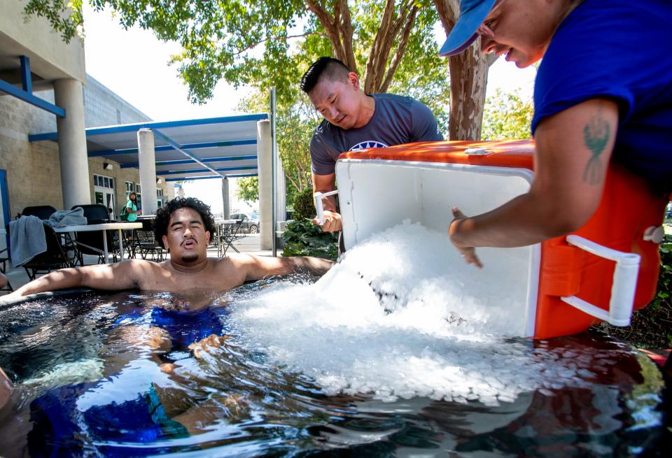 Jairus Satele cools down in an ice tub after a hot practice with the San Jose State football team, Tuesday, Aug. 16, 2022, in San Jose, Calif.