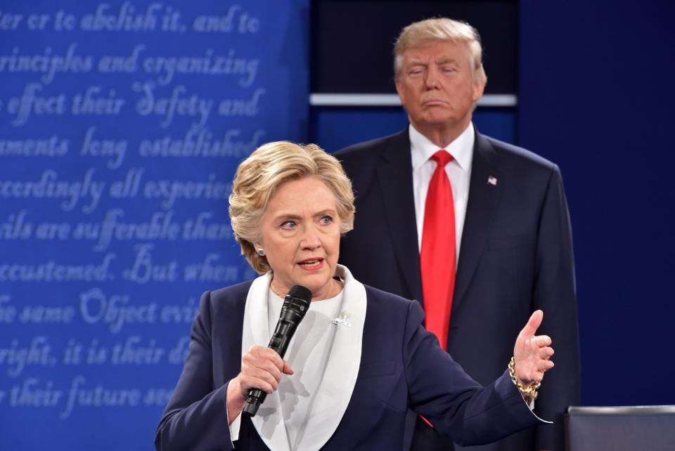 Then-Republican presidential candidate Donald Trump listens to then-Democratic presidential candidate Hillary Clinton during the second presidential debate at Washington University in St. Louis, Missouri, on October 9, 2016.