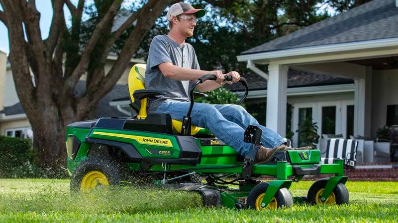 The John Deere Z370R Electric ZTrak Mower being operated on a backyard lawn.