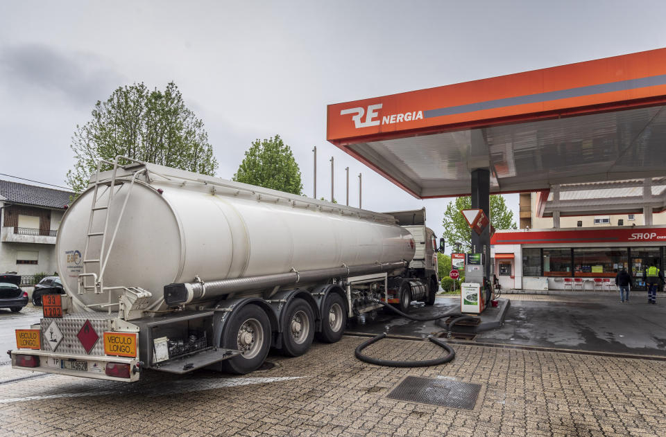 A tank truck delivers fuel at a gas station in Braga, northern Portugal, Wednesday, April 17, 2019. A strike over pay and working conditions by some 800 truckers who transport hazardous materials prompted a rush to fill tanks, leaving dry hundreds of gas stations across Portugal Wednesday. (AP Photo/Luis Vieira)