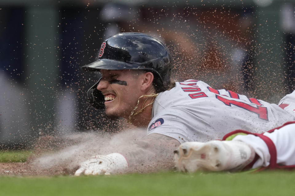 Boston Red Sox's Jarren Duran slides, scoring against the Cincinnati Reds during the eighth inning of a baseball game Saturday, June 22, 2024, in Cincinnati. The Red Sox won 4-3. (AP Photo/Carolyn Kaster)