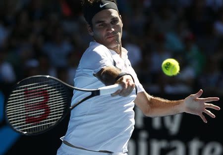 Tennis - Australian Open - Rod Laver Arena, Melbourne, Australia, January 22, 2018. Roger Federer of Switzerland hits a shot against Marton Fucsovics of Hungary. REUTERS/Thomas Peter