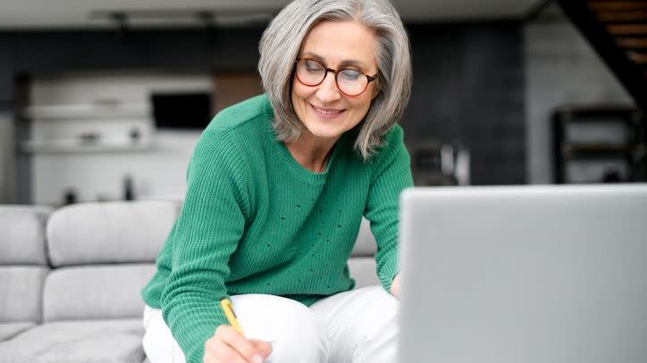 A woman adds up what her estimated expenses will be in retirement.